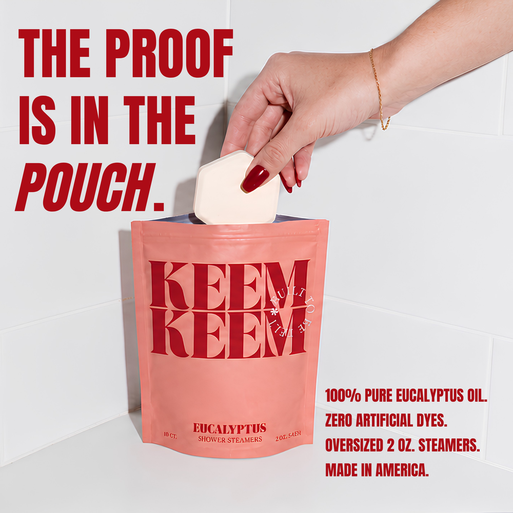 A stand-up pouch of KEEM KEEM Eucalyptus Shower Stamps in a dusty pink color with bold red lettering, styled with eucalyptus leaves and a hexagonal cream-colored stamp on a white background.